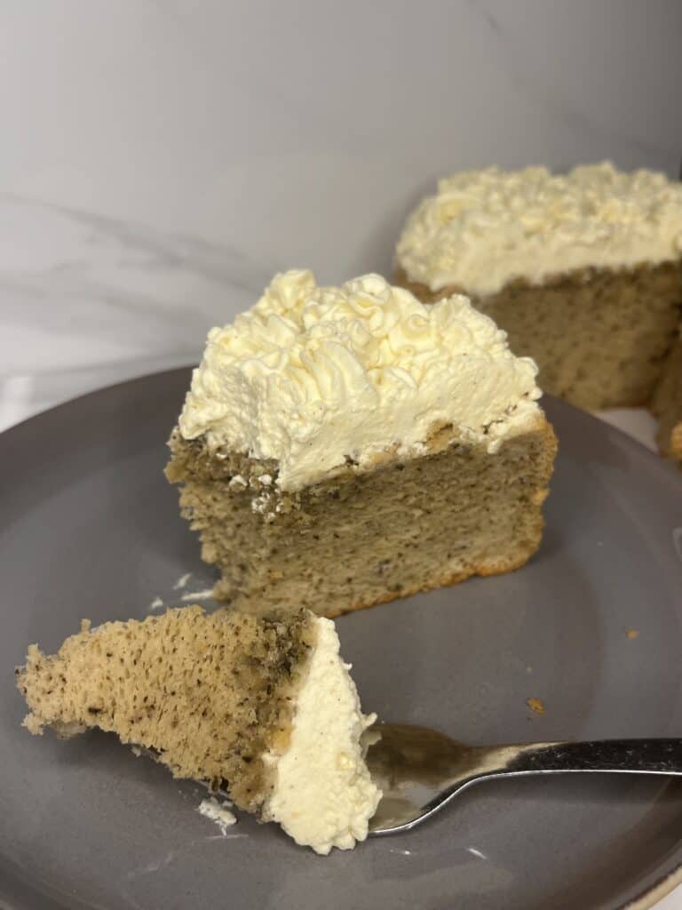 gluten and dairy free earl grey chiffon cake showing how spongy it is, topped with a sweet vanilla cream