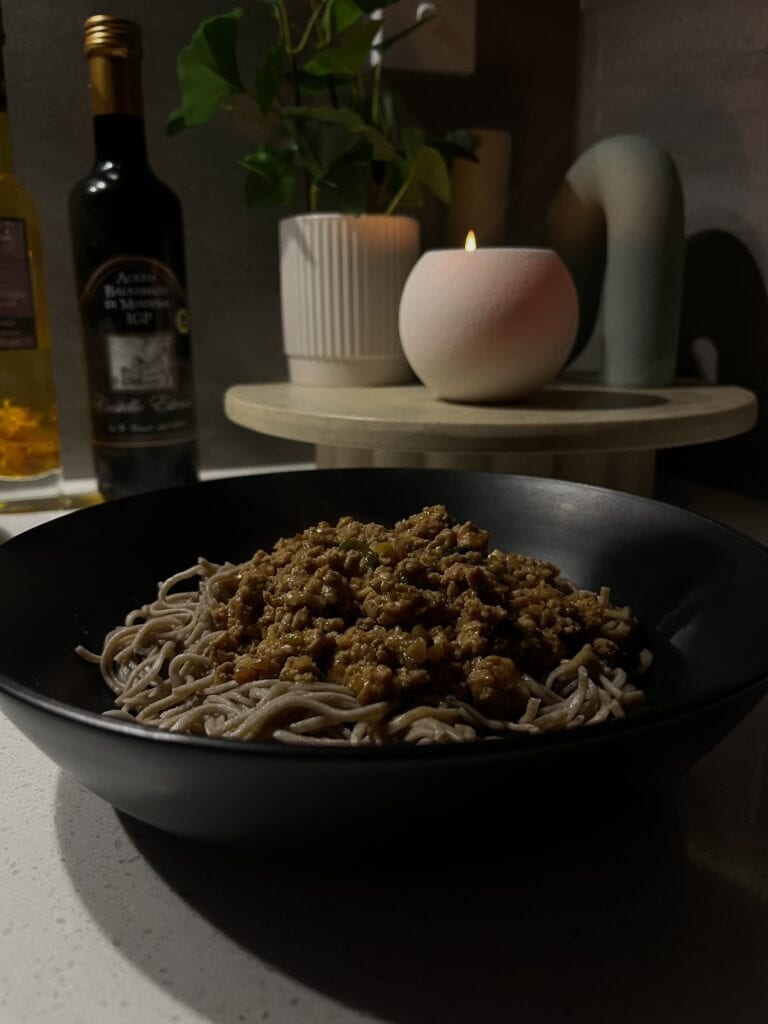 thai pork mince with red curry on soba noodles