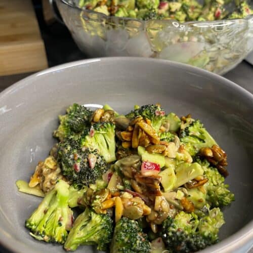 freshly made broccoli salad with almond, pumpkin seeds, pickled red onions, and salad dressing