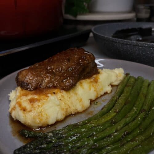 braised short ribs on mashed potato with asparagus