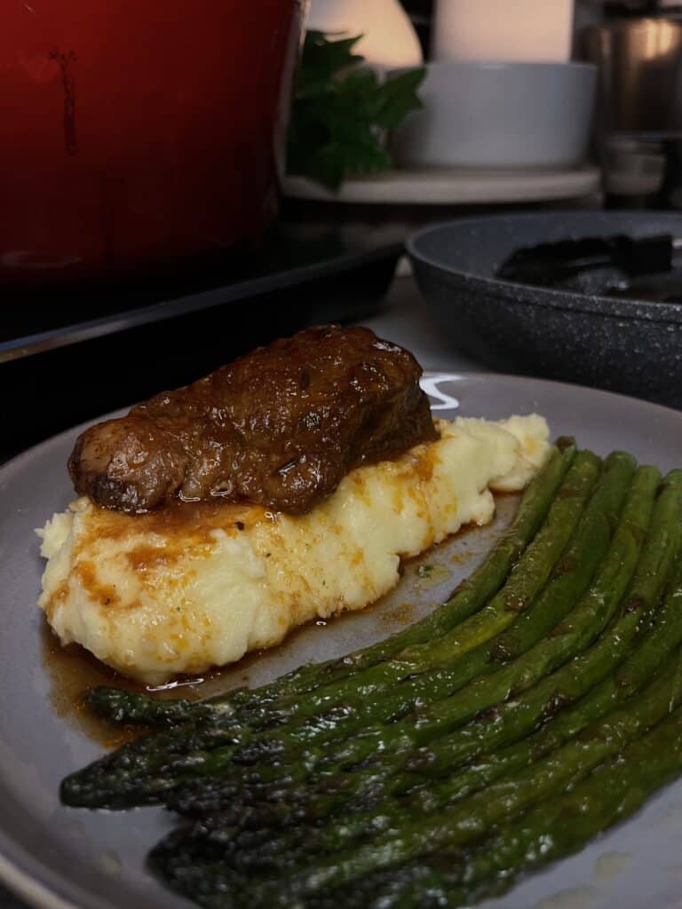 braised short ribs on mashed potato with asparagus