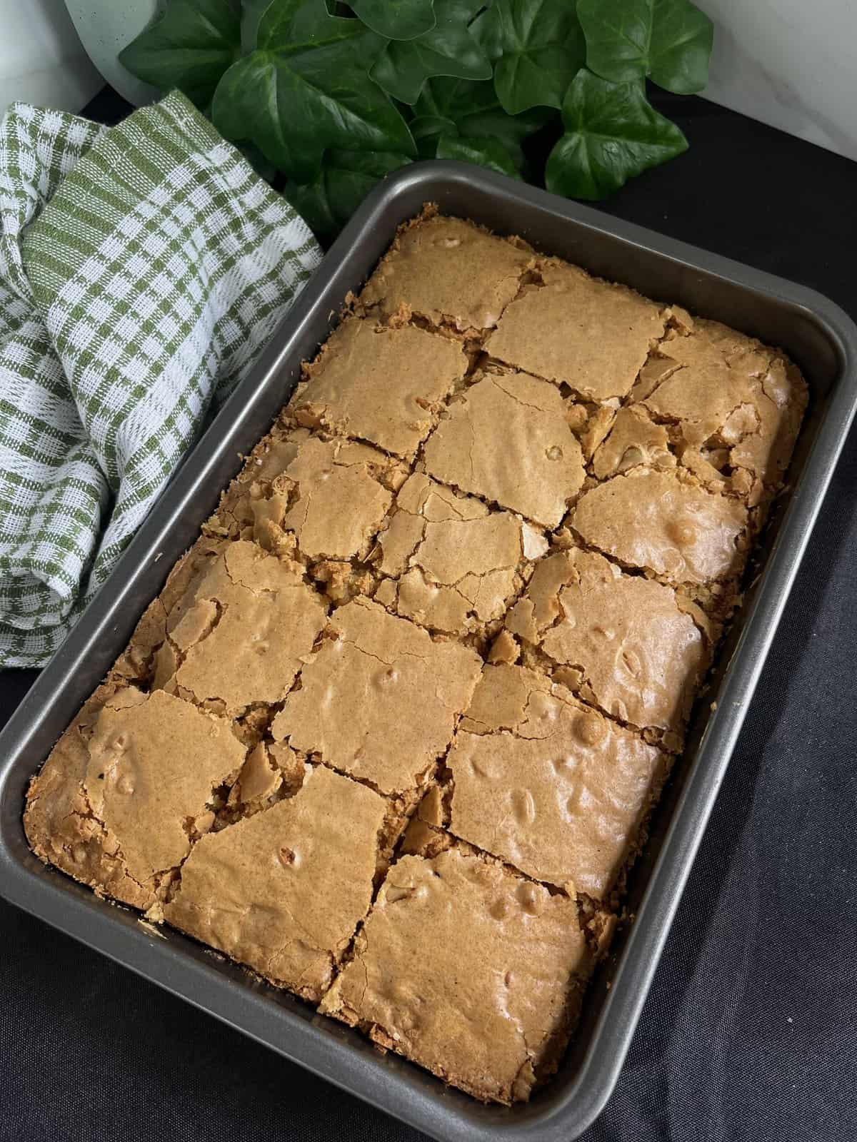 gluten free blondies with white chocolate in a baking dish fresh out the oven cut into squares