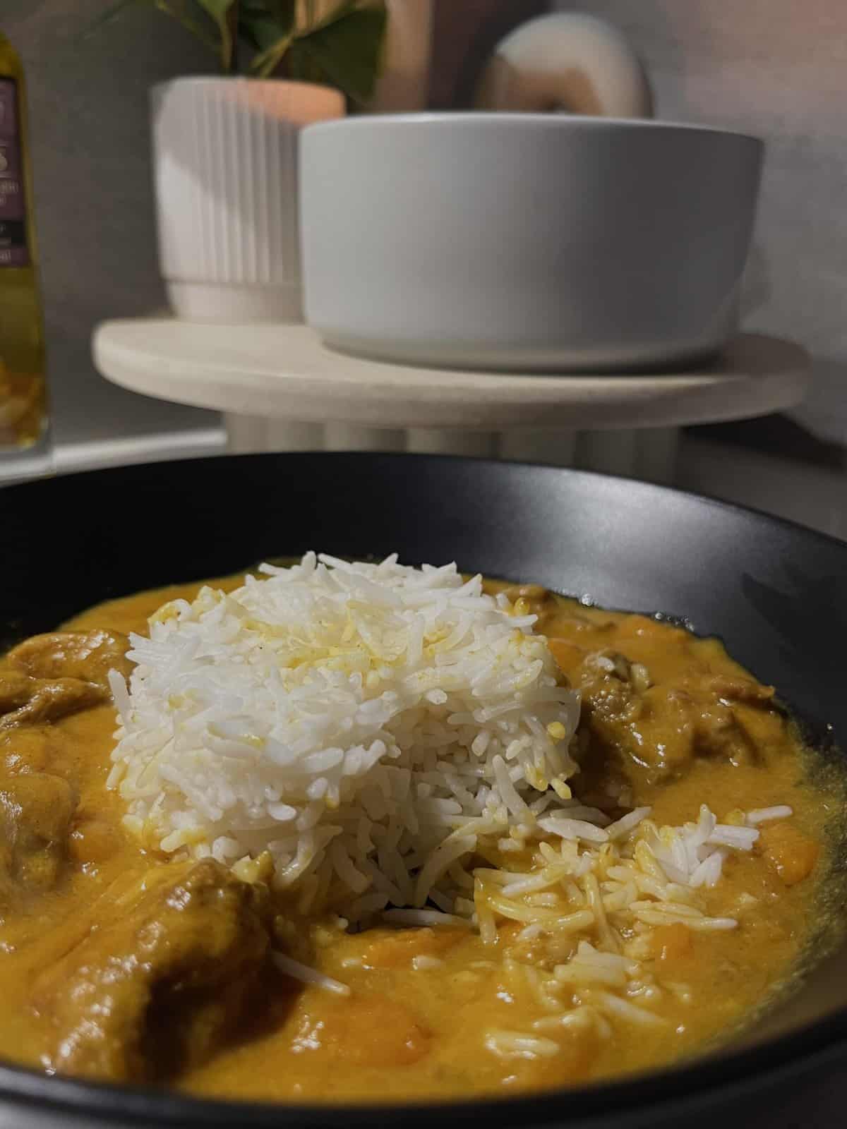 chicken coconut curry with coconut cream and spices on basmati rice