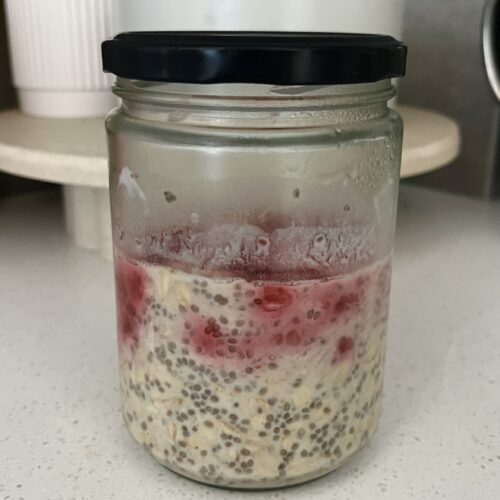 overnight oats with maple syrup, raspberries, chia seeds, and milk