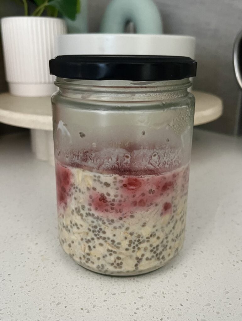 overnight oats with maple syrup, raspberries, chia seeds, and milk