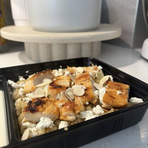 chicken and quinoa meal preparation with feta and almonds, and a lemon honey yoghurt dressing