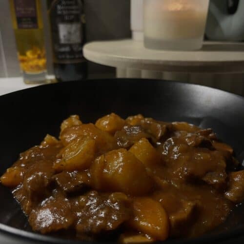 pressure cooked beef stew with a tomato gravy, mushrooms, potatoes, onion and carrots