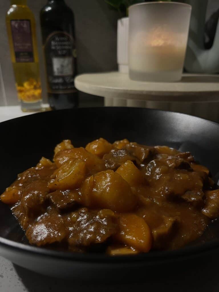 pressure cooked beef stew with a tomato gravy, mushrooms, potatoes, onion and carrots