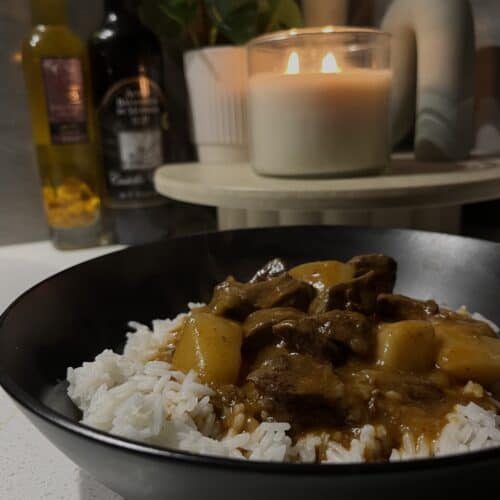 pressure cooked massaman curry on rice, with beef, onions, and potato