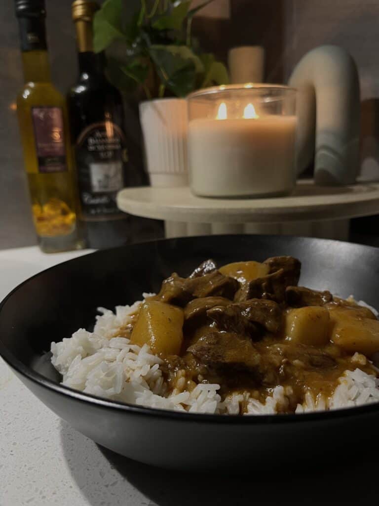 pressure cooked massaman curry on rice, with beef, onions, and potato