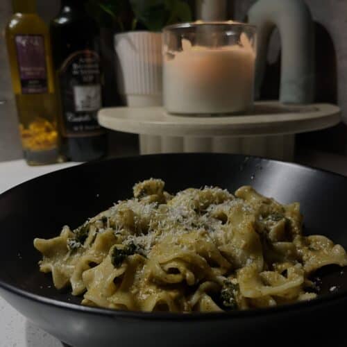 tomato pesto pasta with kale and lasagne pasta, topped with parmesan cheese