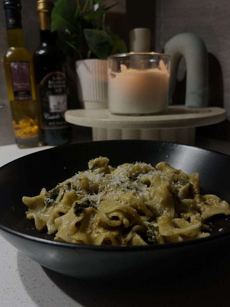 tomato pesto pasta with kale and lasagne pasta, topped with parmesan cheese